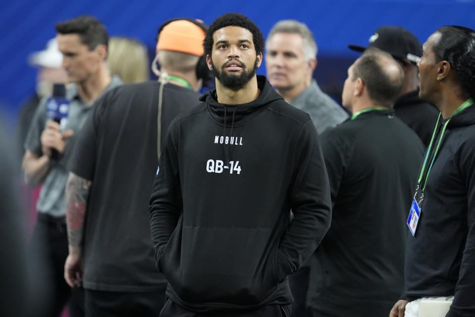 Southern California quarterback Caleb Williams watches as players run a drill at the NFL football scouting combine, Saturday, March 2, 2024, in Indianapolis. (AP Photo/Michael Conroy)