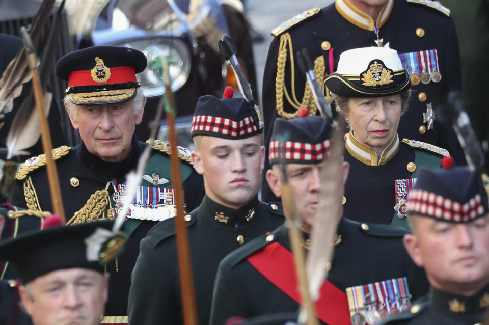 King Charles III and Princess Anne follow the coffin of Queen Elizabeth II in the procession up the Royal Mile to St Giles' Cathedral in Edinburgh, Monday, Sept. 12, 2022. Britain's longest-reigning monarch who was a rock of stability across much of a turbulent century, died Thursday Sept. 8, 2022, after 70 years on the throne. She was 96. (AP Photo/Scott Heppell)