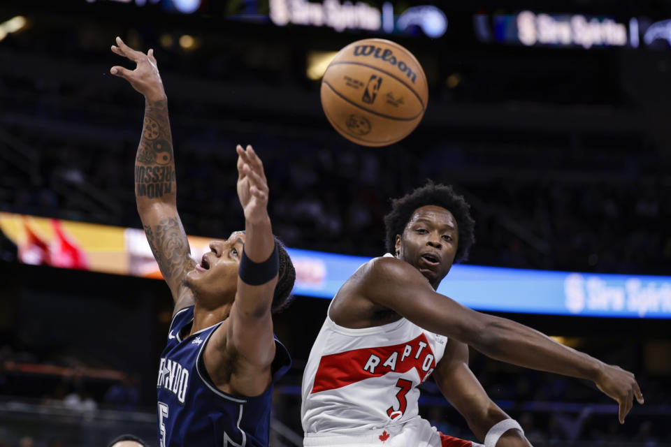 Toronto Raptors forward O.G. Anunoby (3) blocks a shot by Orlando Magic forward Paolo Banchero during the first half of an NBA basketball In-Season Tournament game Tuesday, Nov. 21, 2023, in Orlando, Fla. (AP Photo/Kevin Kolczynski)