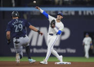 Toronto Blue Jays second baseman Cavan Biggio (8) forces out Seattle Mariners catcher Cal Raleigh (29) at second during the seventh inning of a baseball game in Toronto, Wednesday, April 10, 2024. The Mariners's Dylan Moore was safe at first. (Nathan Denette/The Canadian Press via AP)