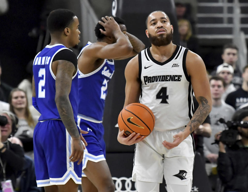 Seton Hall guard Femi Odukale, rear center, reacts to a foul called on him against Providence guard Jared Bynum (4) during the first half of an NCAA college basketball game Saturday, March 4, 2023, in Providence, R.I. At left is Seton Hall guard Al-Amir Dawes (2). (AP Photo/Mark Stockwell)