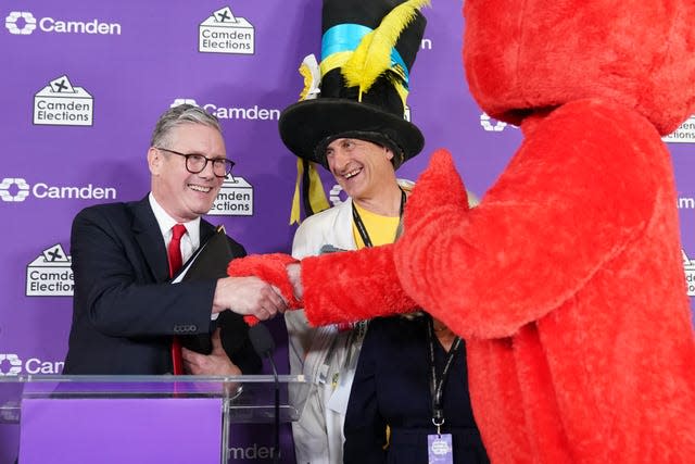 Labour leader Sir Keir Starmer (left) shakes hands with Nick the Incredible Flying Brick (second right) and Bobby “Elmo” Smith (right) 