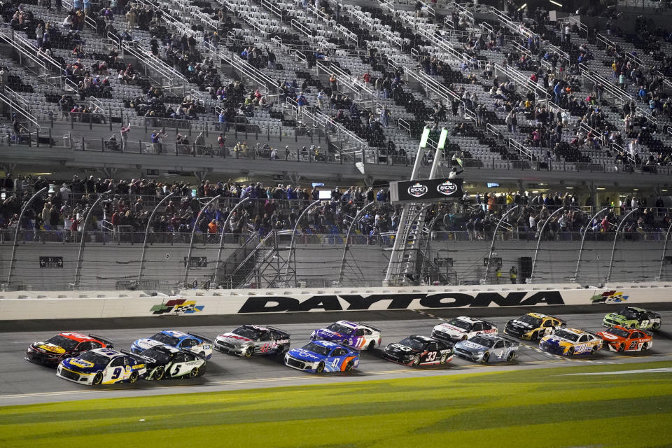 Drivers restart after a weather delay during the NASCAR Daytona 500 auto race at Daytona International Speedway, Sunday, Feb. 14, 2021, in Daytona Beach, Fla. (AP Photo/John Raoux)