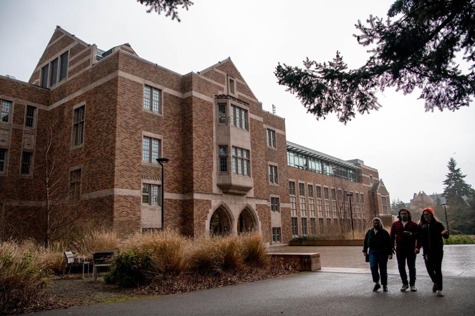 Pedestrians walk past the Husky Union Building on March 20, 2021, on the University of Washington campus in Seattle, Washington.