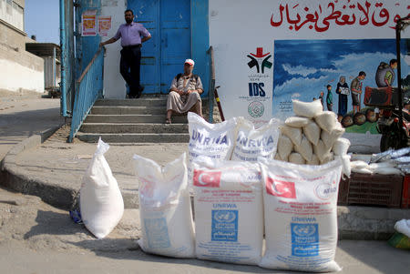 A Palestinian man sits outside an aid distribution center run by United Nations Relief and Works Agency (UNRWA) in Khan Younis in the southern Gaza Strip September 1, 2018. REUTERS/Ibraheem Abu Mustafa