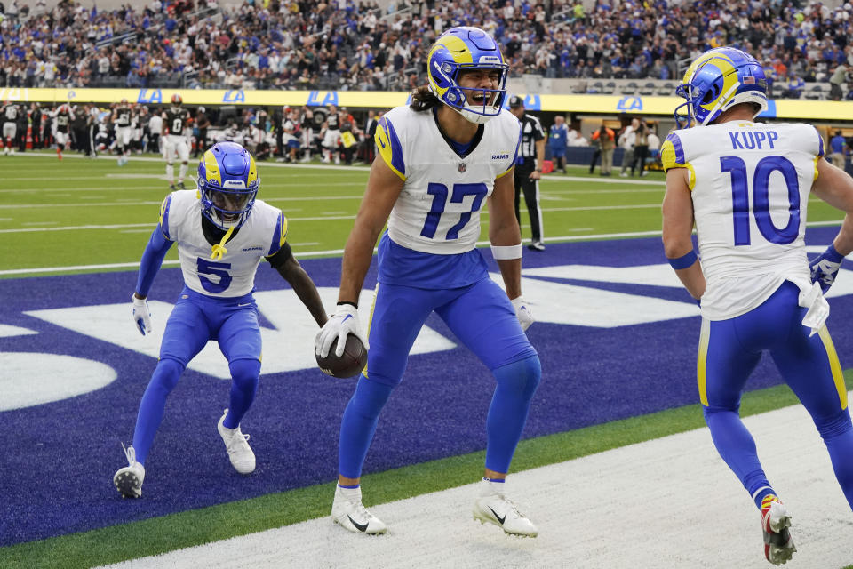 Los Angeles Rams wide receiver Puka Nacua (17) celebrates his touchdown catch with wide receiver Cooper Kupp (10) and wide receiver Tutu Atwell (5) during the first half of an NFL football game against the Cleveland Browns, Sunday, Dec. 3, 2023, in Inglewood, Calif. (AP Photo/Mark J. Terrill)