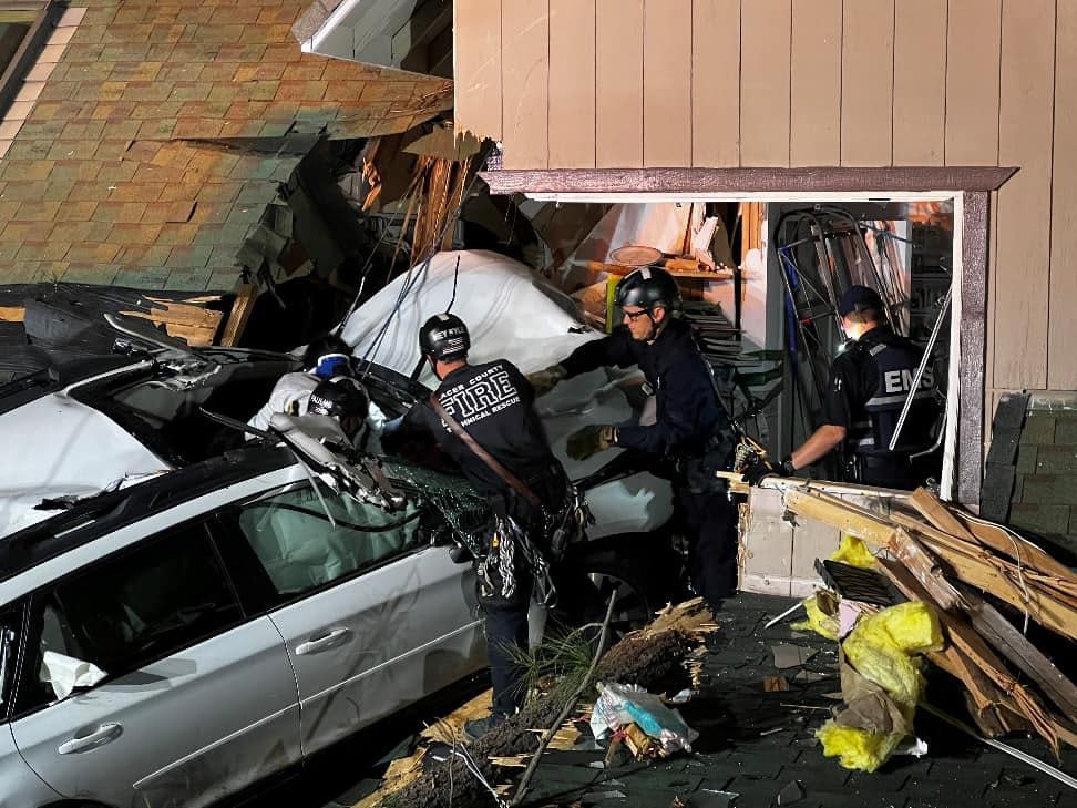 Responders after a white SUV landed on a carport and crashed into the second story of a California home. / Credit: CAL FIRE Nevada Yuba Placer Unit