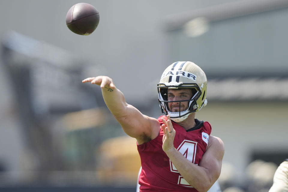 New Orleans Saints quarterback Derek Carr (4) passes during an NFL football practice in Metairie, La., Tuesday, May 23, 2023. (AP Photo/Gerald Herbert)