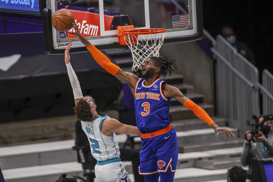 New York Knicks center Nerlens Noel (3) blocks a shot by Charlotte Hornets guard LaMelo Ball (2) in the first quarter of an NBA basketball game in Charlotte, N.C., Monday, Jan. 11, 2021. (AP Photo/Nell Redmond)