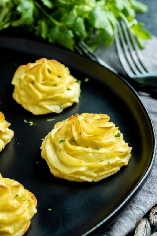 <p>Homemade Interest</p><p>This easy duchess potatoes recipe is an elegant potato recipe that is perfect for the holidays. They can even be made ahead of time and frozen to save you time on the day of your dinner party!</p><p><strong>Get the recipe: <a href="https://www.homemadeinterest.com/duchess-potatoes/" rel="nofollow noopener" target="_blank" data-ylk="slk:Duchess Potatoes;elm:context_link;itc:0;sec:content-canvas" class="link ">Duchess Potatoes</a></strong></p>