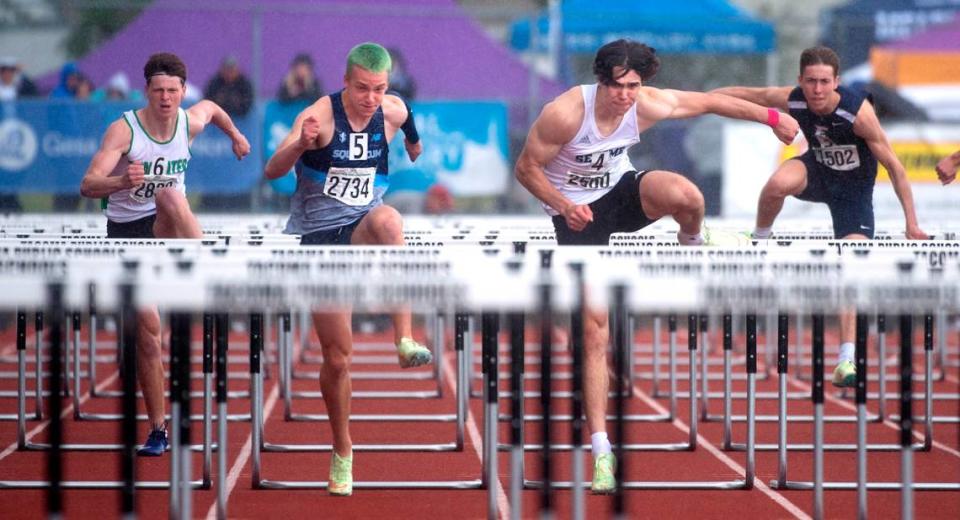 Squalicum’s Andre Korbmacher, left, tops Sehome’s Carter Birade to take the state championship in the 2A boys 110-meter high hurdles during the second day of the WIAA State Track and Field Championships at Mount Tahoma High School in Tacoma, Washington, on Friday, May 27, 2022.