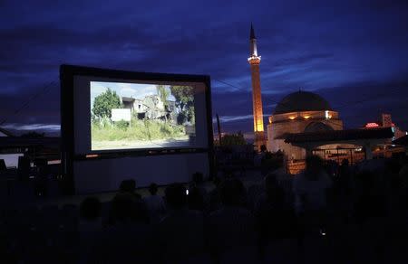 Kosovars and foreign visitors take their seats on a raised platform to watch a documentary film during Dokufest in Prizren August 20, 2014. REUTERS/Hazir Reka