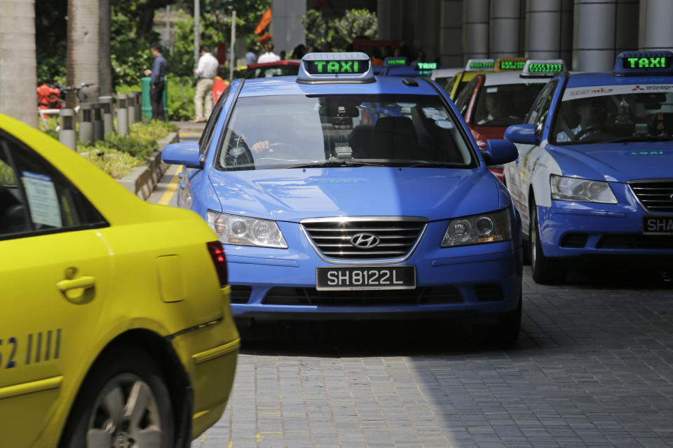ComfortDelGro taxis wait in front of an office building on 17 May, 2016, in Singapore. (AP file photo)