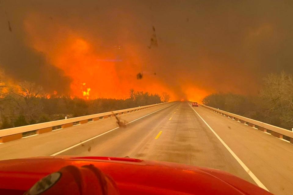 PHOTO: This handout picture courtesy of the Greenville Professional Firefighters Association, Feb. 27, 2024, shows a fire truck driving towards the Smokehouse Creek Fire, near Amarillo, in the Texas Panhandle.  (Greenville Professional Firefighters Association/AFP via Getty Images)