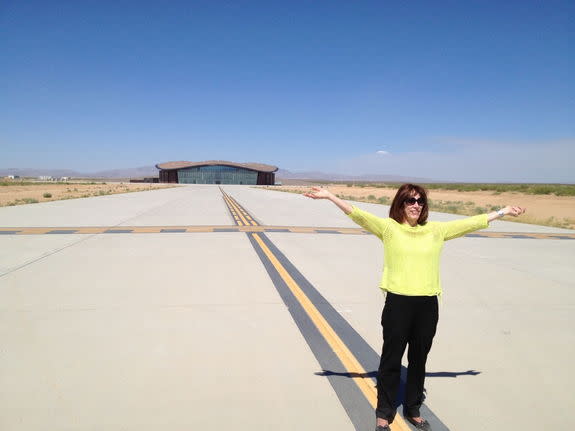 Ready for flight is Christine Anderson, executive director of the New Mexico Spaceport Authority. Virgin Galactic's terminal and hangar facility looms large in the background.