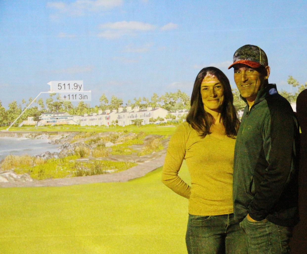 With the famed 18th hole at Pebble Beach in the background, Bobbi, left, and Brian Ludwig stand inside the golf simulator at Iron Cave Golf in Chenoa, which opened recently.