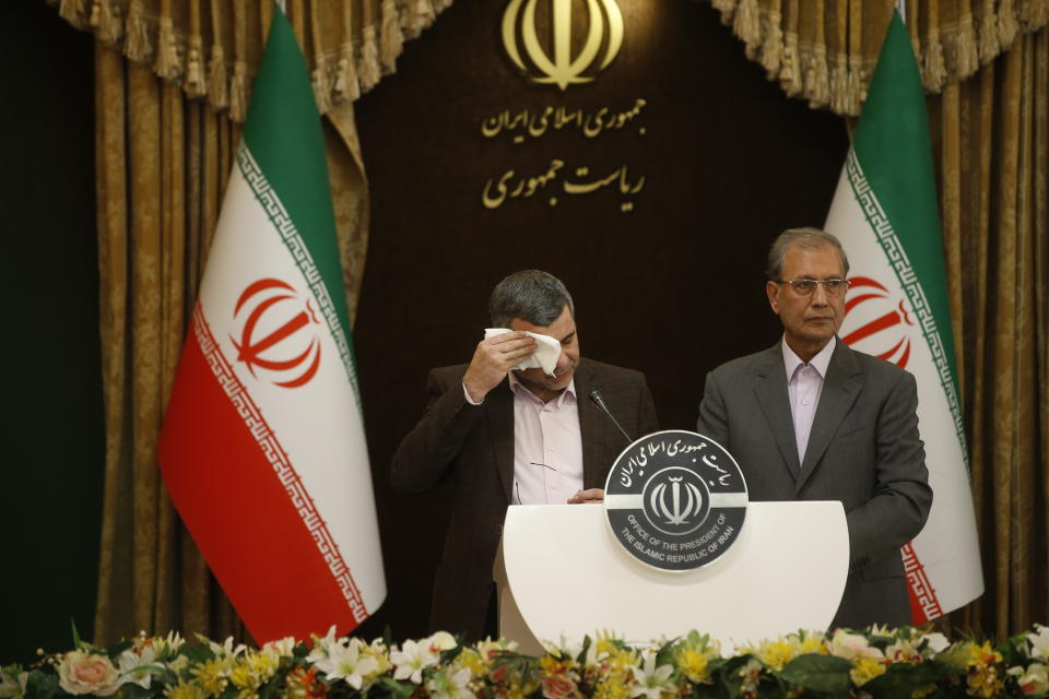 TEHRAN, IRAN - FEBRUARY 24: Iranian Deputy Health Minister Iraj Harirchi (L) wipes his sweating as he speaks on his tests positive for coronavirus as he holds a press conference with Iranian Government spokesman and Spokesperson for the Prevention and Struggle for Corona, created by Iranian President Hassan Rouhani, Ali Rabiei (R) in Tehran, Iran on February 24, 2020. (Photo by Stringer/Anadolu Agency via Getty Images)