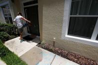 A protesters kicks the door of the Florida home of former Minneapolis police officer Derek Chauvin, in Orlando