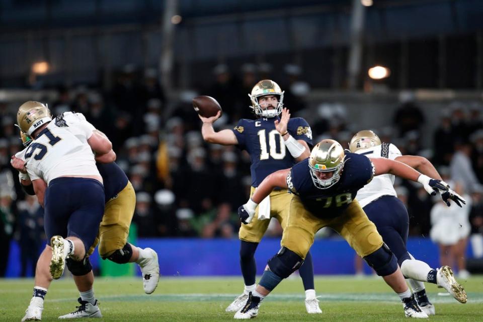 Notre Dame quarterback Sam Hartman (10) throws against Navy during an NCAA college football game in Dublin, Ireland, Aug. 26, 2023. (AP Photo/Peter Morrison)