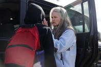 Jessie Blanchard talks with a participant near her jeep, outside of a motel where she hands out goods like Naloxone, tourniquet, needles, food, and other materials to help the community, on Monday, Jan. 23, 2023, in Albany, Ga. Blanchard started small nearly five years ago, just trying to get enough of the rescue drug naloxone that reverses opioid overdoses to keep her daughter from dying from an overdose. (AP Photo/Brynn Anderson)