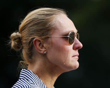 Sydney resident Kate Golder cries as she observes the site of a Sydney cafe siege after it ended in Martin Place, December 16, 2014. REUTERS/Jason Reed