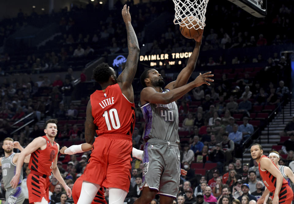 Sacramento Kings forward Harrison Barnes, right, puts a shot on Portland Trail Blazers forward Nassir Little, left, during the first half of an NBA basketball game in Portland, Ore., Wednesday, March 29, 2023. (AP Photo/Steve Dykes)