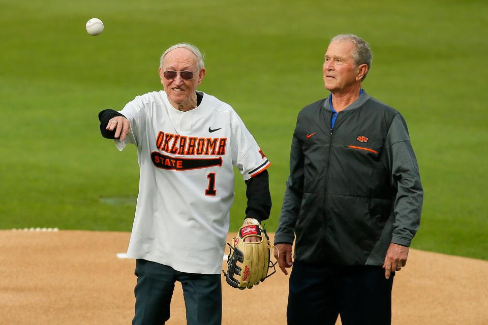 Former President George W. Bush watches as Cecil O'Brate throws out the first pitch before a baseball game between the Oklahoma State Cowboys (OSU) and New Orleans at O'Brate Stadium in Stillwater, Okla., Thursday, May 20, 2021. 