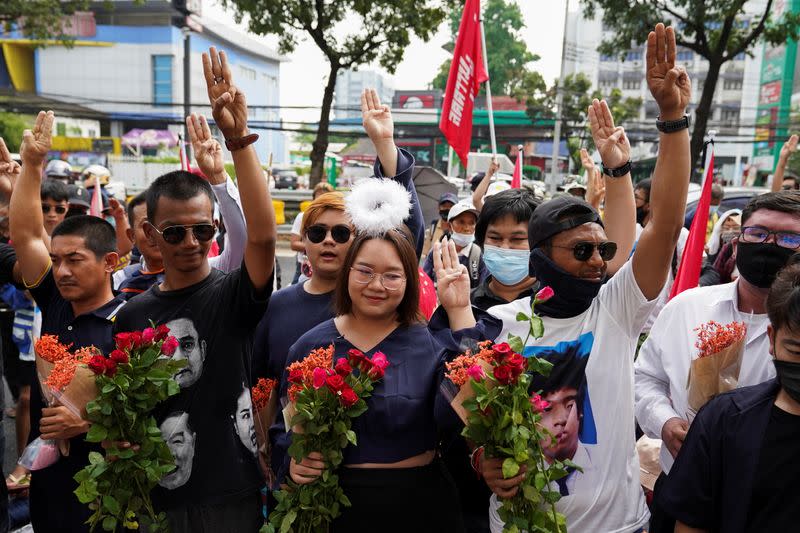 Anti-government protesters leaders Panusaya "Rung" Sithijirawattanakul, Panupong "Mike" Jadnok, and Jatupat "Pai" Boonpattararaksa arrive to report themselves over royal insult charges, at the Attorney General's office in Bangkok