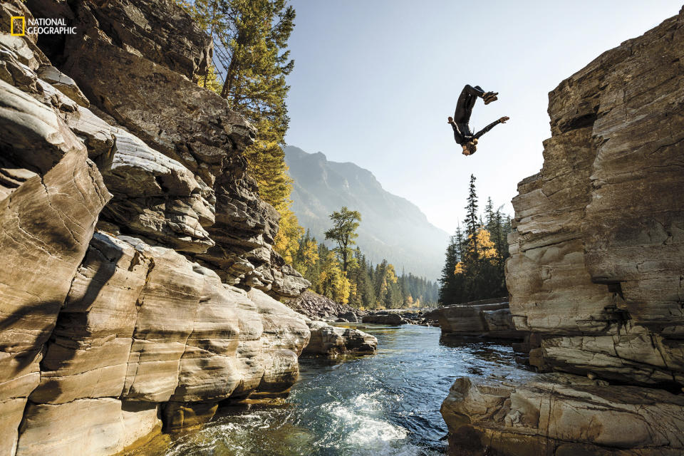 <p>Daredevil Steven Donovan flips into a pool in Glacier National Park. (Corey Arnold/National Geographic) </p>