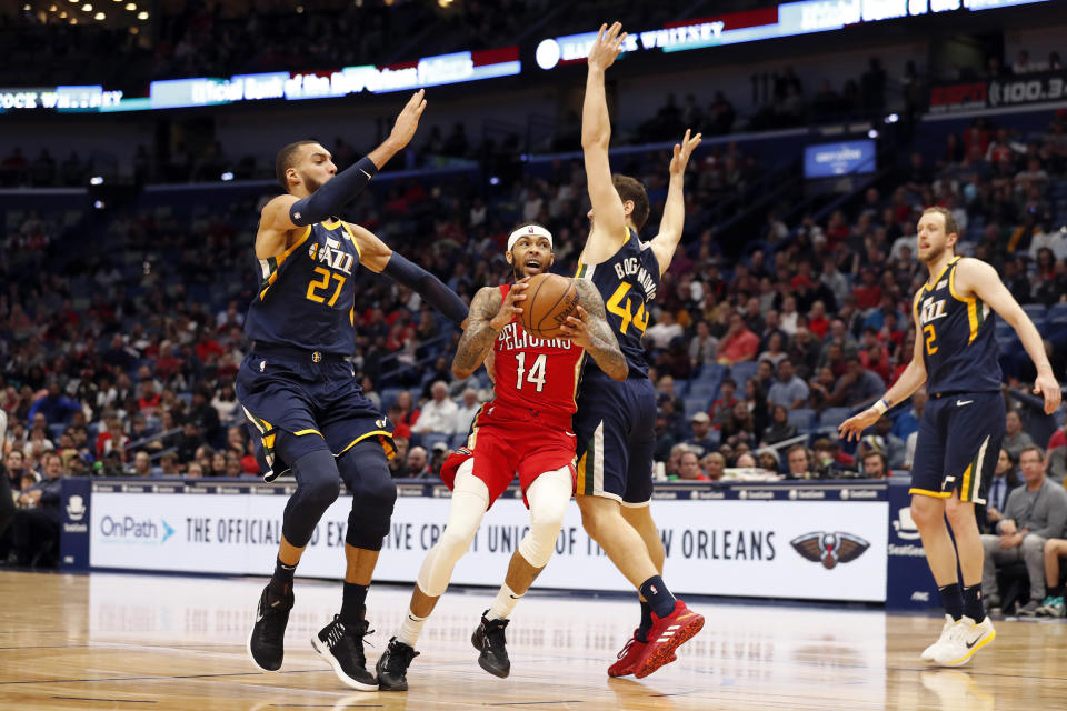 New Orleans Pelicans forward Brandon Ingram (14) drives between Utah Jazz center Rudy Gobert (27) and forward Bojan Bogdanovic (44) in the first half of an NBA basketball game in New Orleans, Monday, Jan. 6, 2020. (AP Photo/Tyler Kaufman)