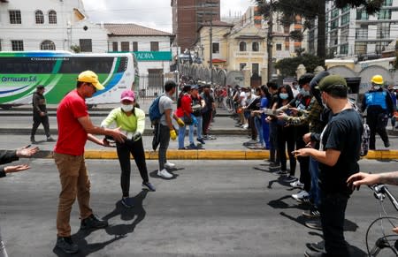 People clean debris from the streets in the aftermath of the last days' protests in Quito