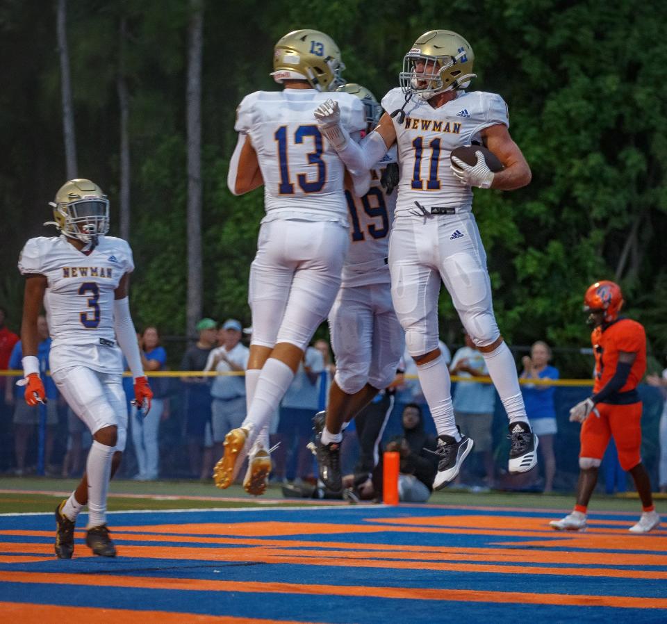 Crusader Chris Presto (11) celebrates his touchdown reception during first half action as The Benjamin School Buccaneers hosts the Cardinal Newman Crusaders during Florida High School Athletic Association boys football action at Theofilos Field at The Benjamin School in Palm Beach Gardens, Fla., on September 9, 2022.