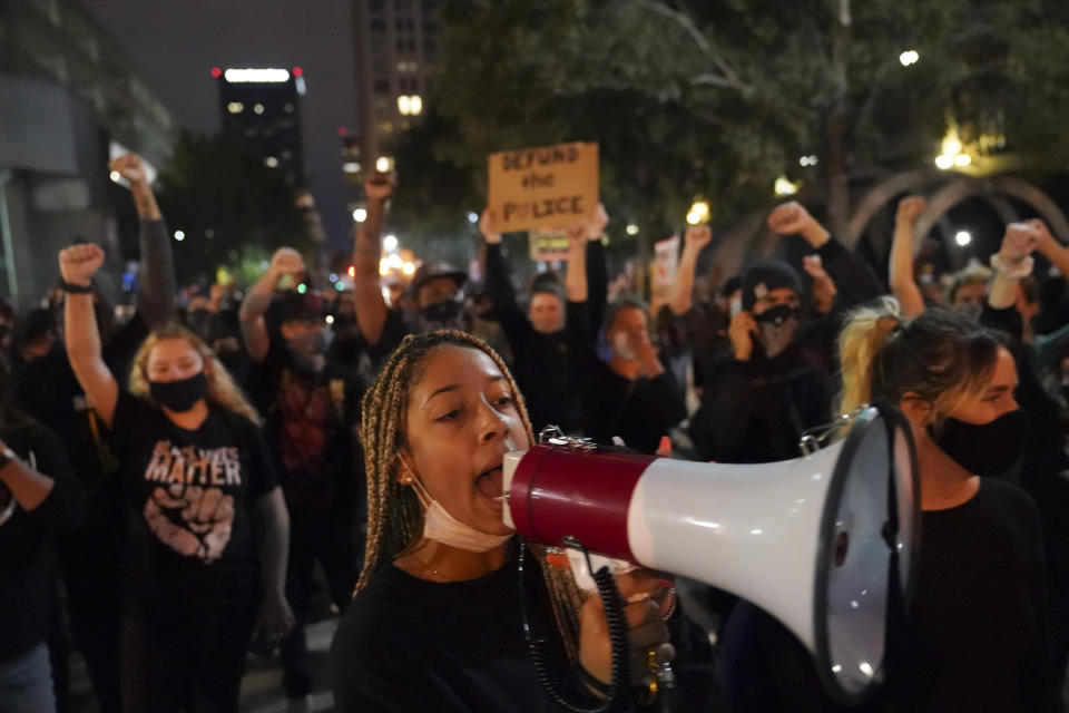 Protesters march, Thursday, Sept. 24, 2020, in Louisville, Ky. Authorities pleaded for calm while activists vowed to fight on Thursday in Kentucky's largest city, where a gunman wounded two police officers during anguished protests following the decision not to charge officers for killing Breonna Taylor. (AP Photo/John Minchillo)