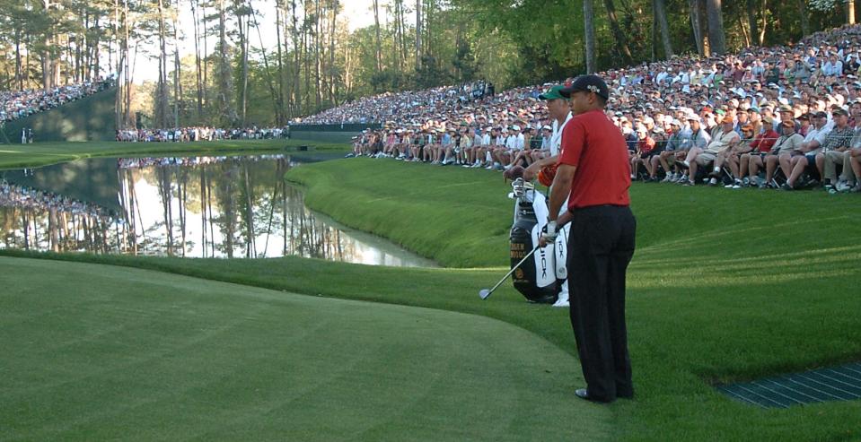 Tiger Woods y su caddie, Steve Williams, observan el icónico chip de Woods para birdie en el hoyo 16 durante la ronda final del Torneo Masters de 2005.