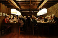 In this March 20, 2017 photo people have dinner at a restaurant during an activity called "The Argentine Experience" in Buenos Aires, Argentina. Tourists participating in "The Argentine Experience" have the chance to learn about the local cuisine, wine and traditions during a dinner in Buenos Aires. (AP Photo/Natacha Pisarenko)