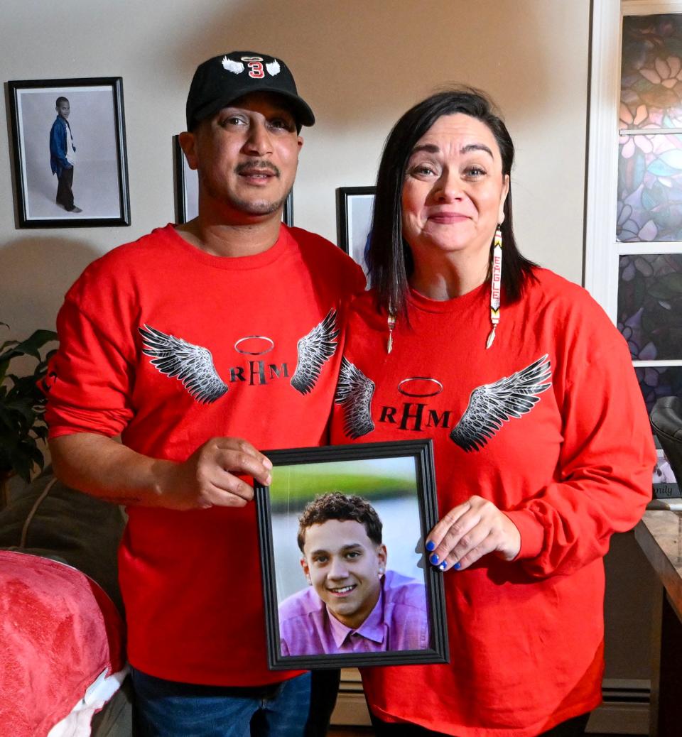 Robbie and Kelley Hendricks of Mashpee hold a photo on Feb. 15 of their son, Ryan, a 2021 Mashpee Middle-High School graduate who died in a 2022 car crash. The couple has created, in their son's name, a student scholarship fund and a foundation to help families who have lost a loved one.