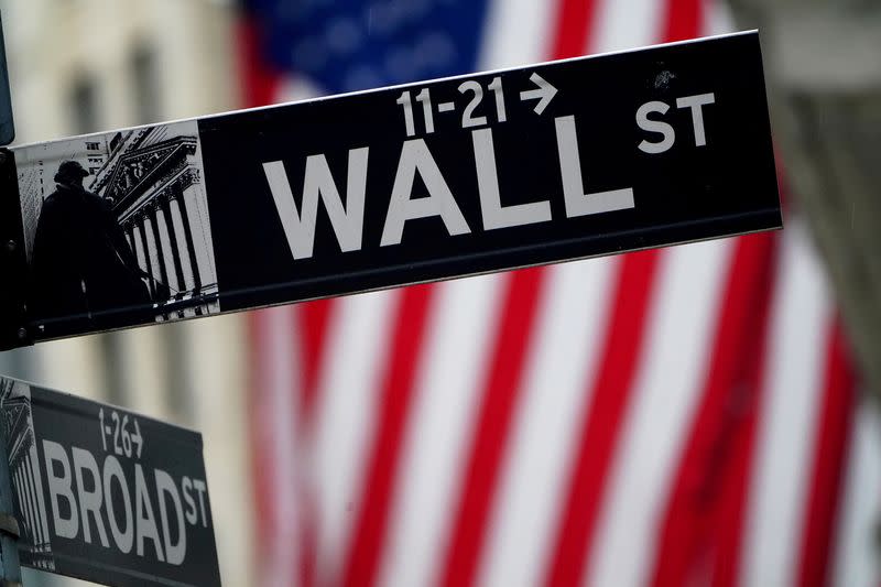 FILE PHOTO: A Wall Street sign is pictured outside the New York Stock Exchange, in New York City, U.S.