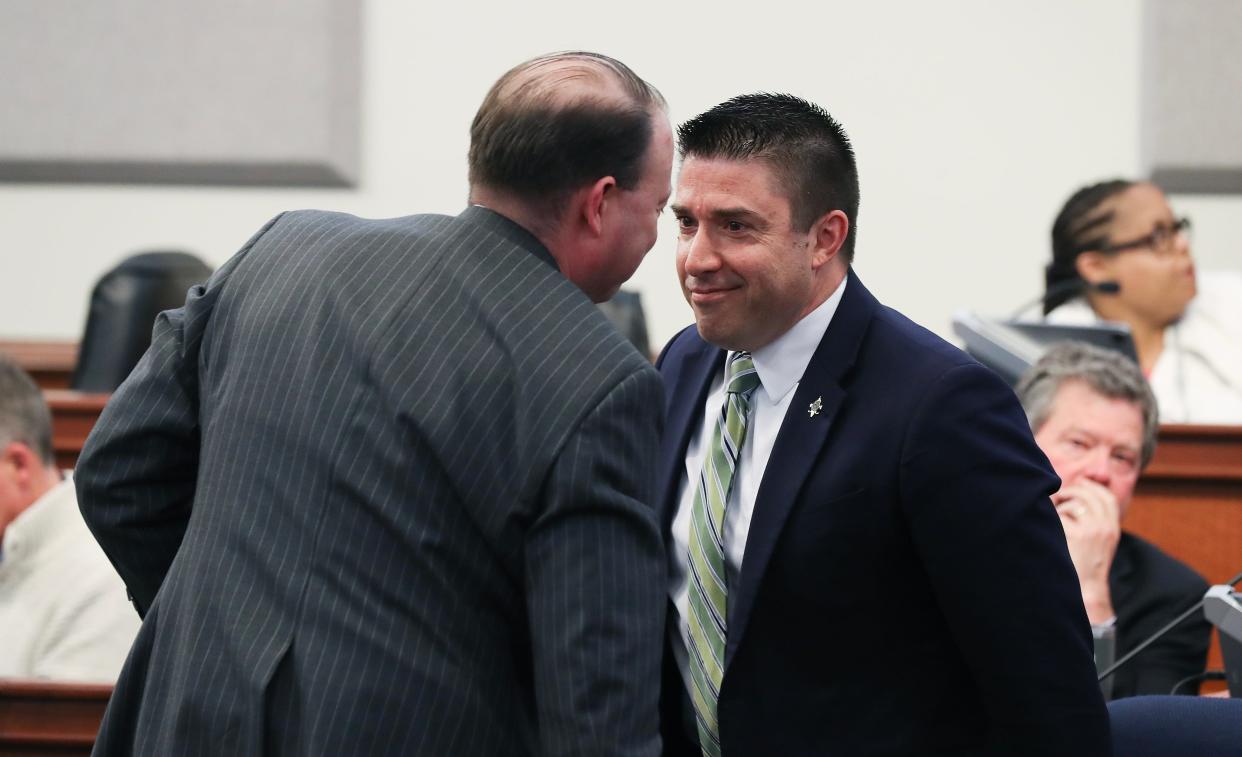 Councilman Anthony Piagentini, right, smiled at his attorney J. Brooken Smith after he was cleared of charges during his removal proceeding in Metro Council at Louisville Metro Council chambers in Louisville, Ky. on Mar. 18, 2024. He will retain his seat on the council.