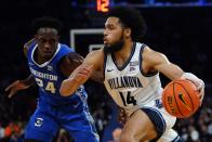 Villanova's Caleb Daniels (14) drives past Creighton's Arthur Kaluma (24) during the first half of an NCAA college basketball game in the final of the Big East conference tournament Saturday, March 12, 2022, in New York. (AP Photo/Frank Franklin II)