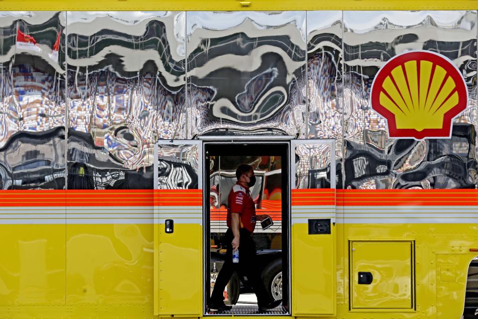 A crew member walks through the Team Penske truck prior to a NASCAR Cup Series auto race at Charlotte Motor Speedway Sunday, May 24, 2020, in Concord, N.C. (AP Photo/Gerry Broome)