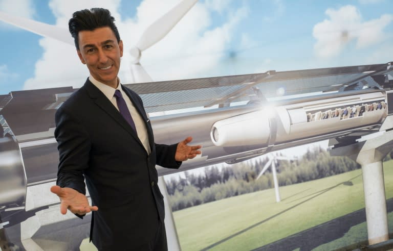 Chairman of Hyperloop Transportation Technologies Inc Bibop Gresta poses in front of a rendering of the Hyperloop technology at Innotrans in Berlin on September 20, 2016