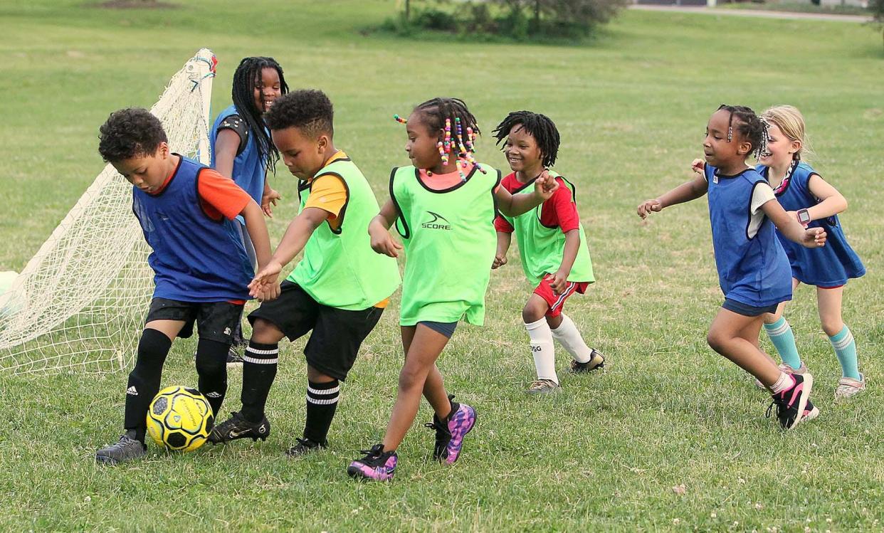 Young aspiring soccer players go after the ball during the 15th annual free summer soccer camp put on by the Akron Inner City Soccer Club at Hardesty Park in Akron on Monday.