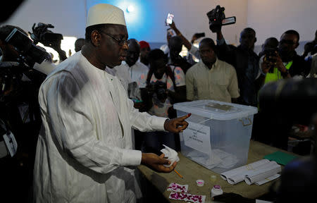 Senegal's President and candidate for the presidential elections Macky Sall shows his ink-stained finger as he casts his vote, at a polling station in Fatick, Senegal February 24, 2019. REUTERS/Zohra Bensemra