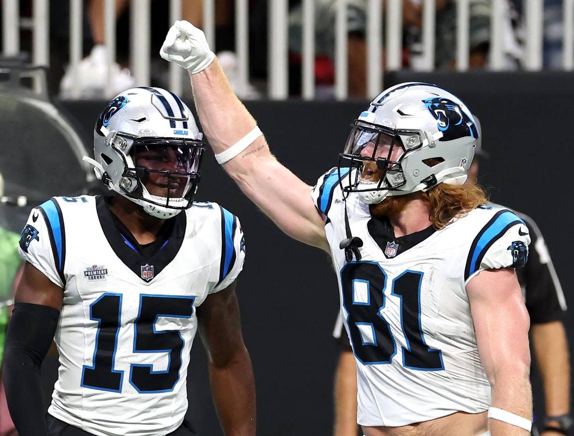 Carolina Panthers tight end Hayden Hurst, right, celebrates his touchdown pass reception during second quarter action against the Atlanta Falcons at Mercedes-Benz Stadium in Atlanta, GA on Sunday, September 10, 2023. At left is wide receiver Jonathan Mingo.