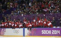Canada players on the bench celebrate after their team defeated Team USA in their men's ice hockey semi-final game at the 2014 Sochi Winter Olympic Games, February 21, 2014. REUTERS/Jim Young