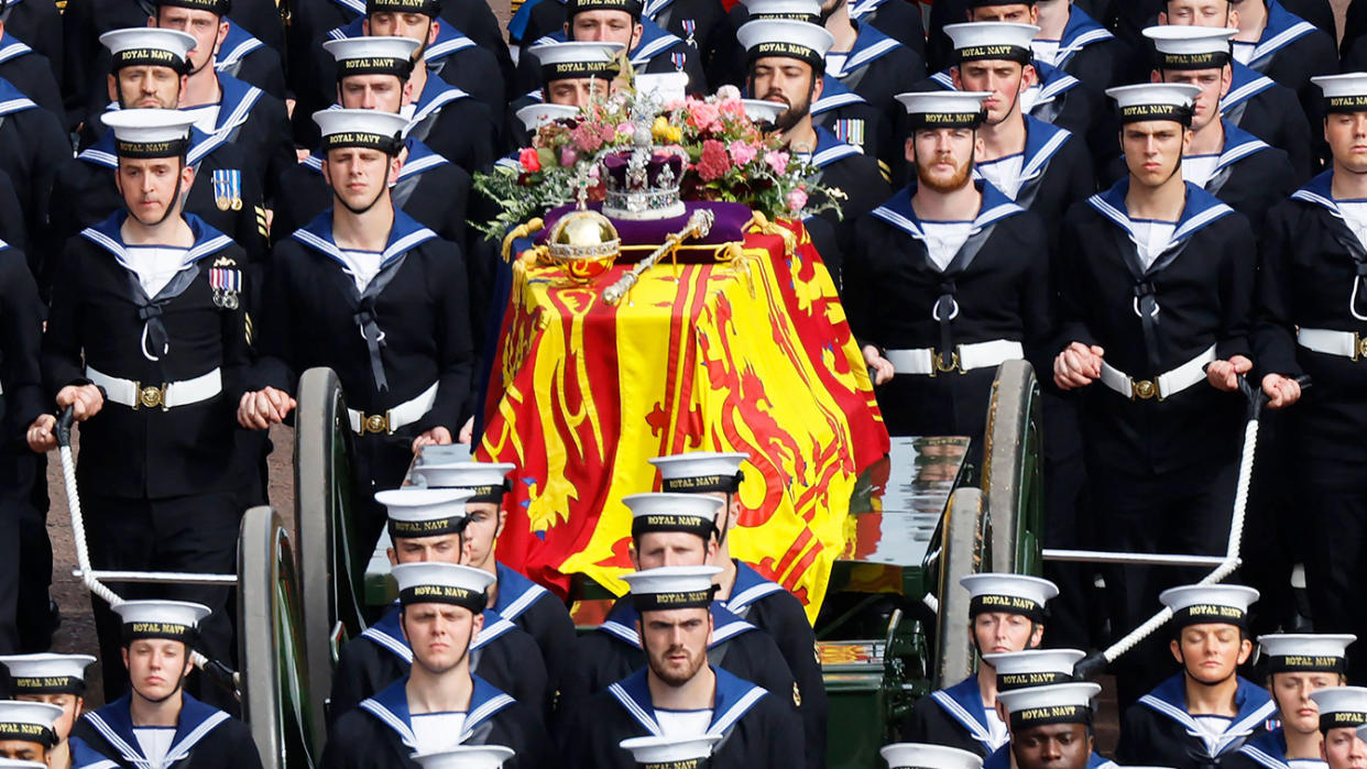 The queen's funeral cortege borne on the state gun carriage of the Royal Navy travels along the Mall. 