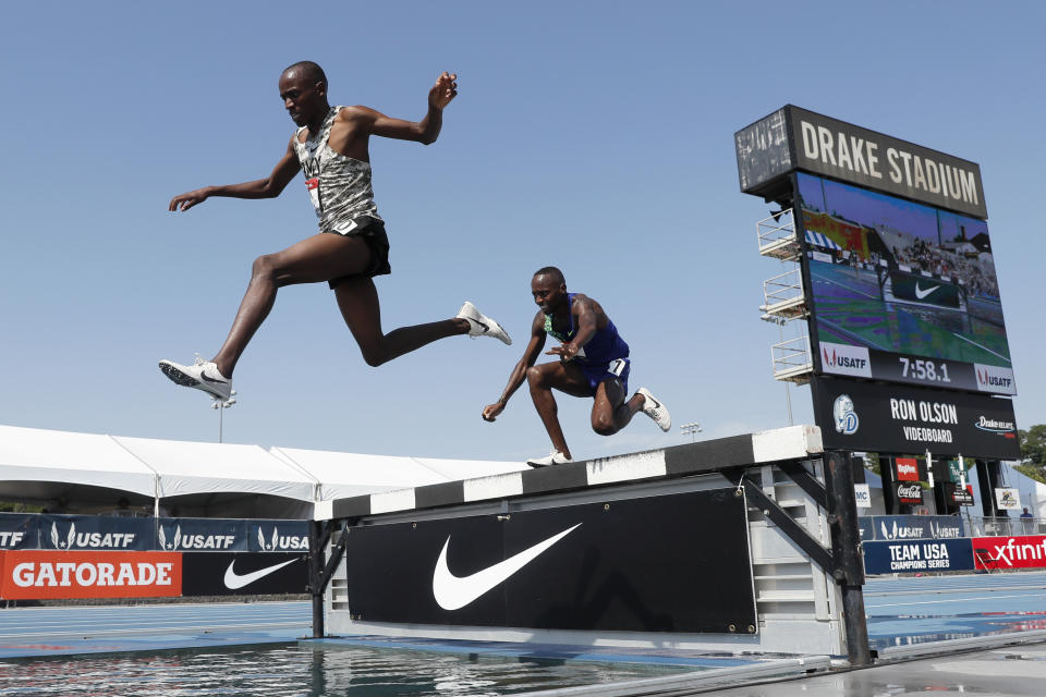 Hillary Bor, left, leaps over the water pit ahead of Stanley Kebenei, right, during the men's 3,000-meter steeplechase at the U.S. Championships athletics meet, Saturday, July 27, 2019, in Des Moines, Iowa. (AP Photo/Charlie Neibergall)