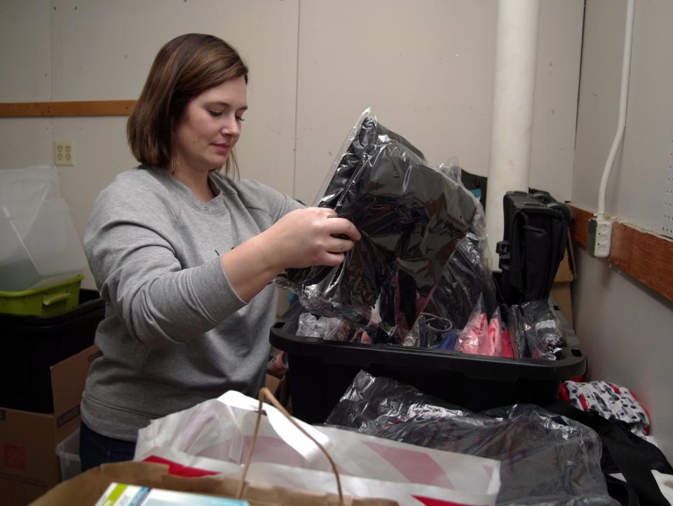 Wandering Heart co-founder Amanda Durante of Bridgewater goes through donated bags and backpacks at the Foundation's warehouse on Liberty Street in Rockland on Wednesday, Jan. 19, 2022.