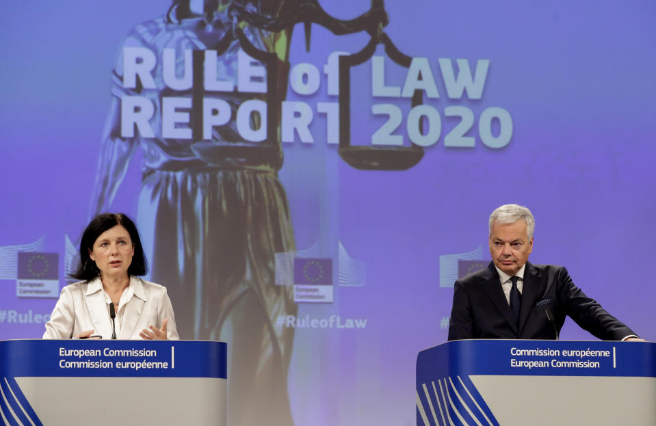 European Commissioner for Values and Transparency Vera Jourova, left, and European Commissioner for Justice Didier Reynders, participate in a media conference on the Rule of Law Report 2020 at EU headquarters in Brussels, Wednesday, Sept. 30, 2020. (Olivier Hoslet, Pool via AP)