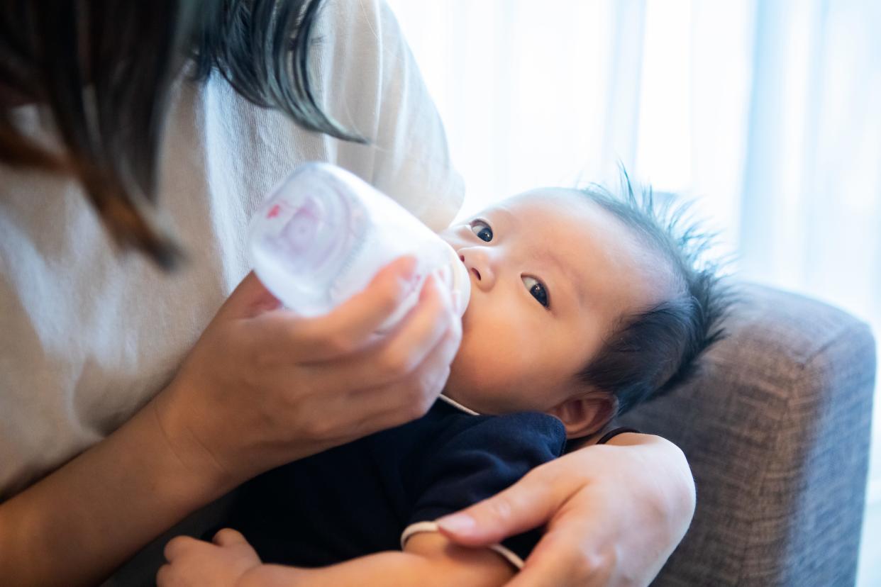 Baby boy drinking form a bottle